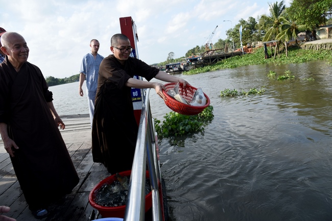 Praying for rebirth and releasing creatures in Ba Lua port, Cu Chi